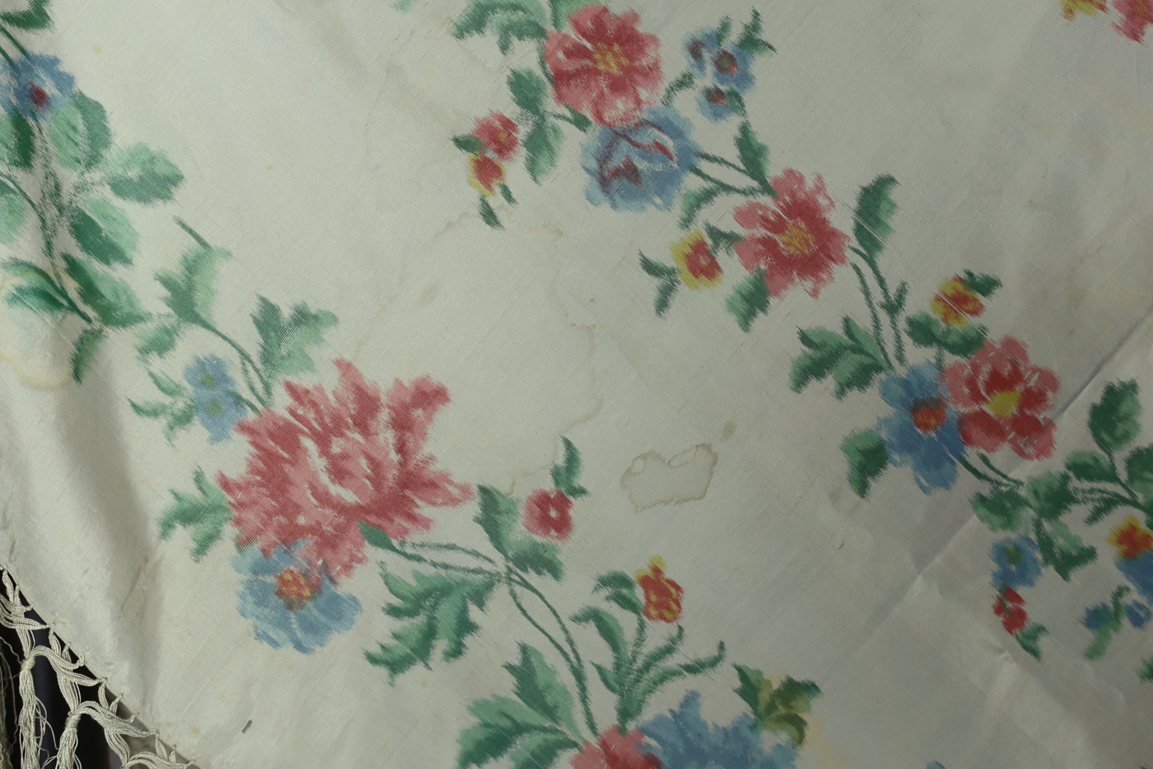 A French silk shawl, c.1800-1840, of a type modelled by Madame Recamier in the painting by François Gerard, printed on the warp thread into a rose pattern, with long fringing, 174 x 170cm